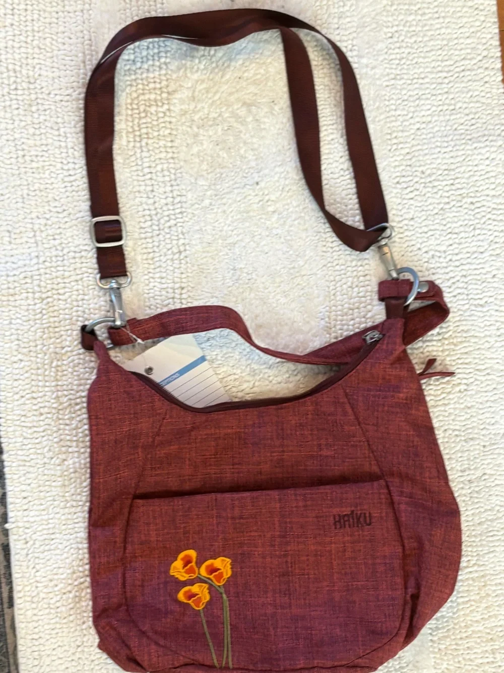 Haiku Amble Hobo Bag in Rust Red with Yellow Floral Detail
